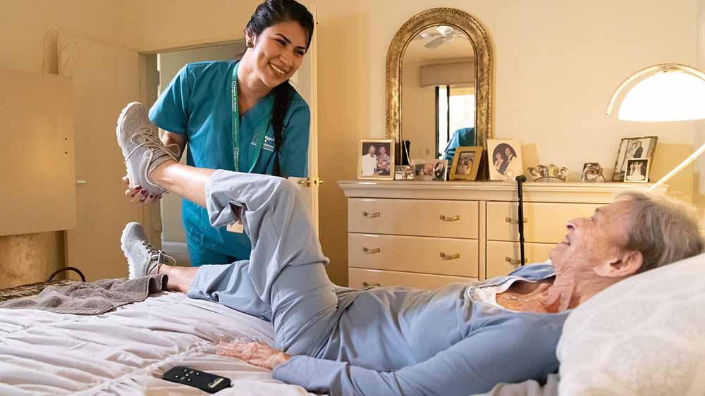 caregiver helping senior recuperate at home